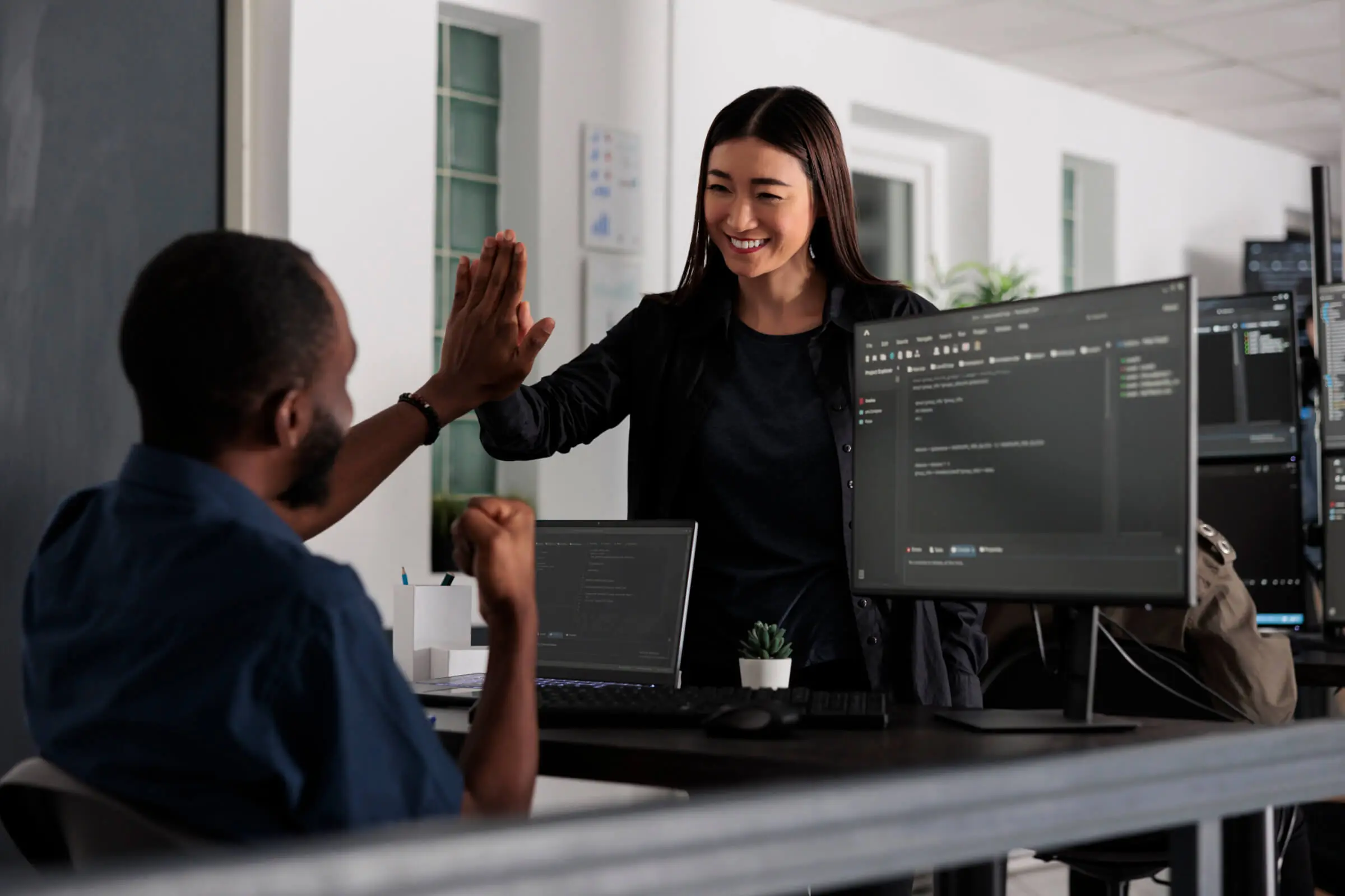 Happy system engineers celebrating successful code.