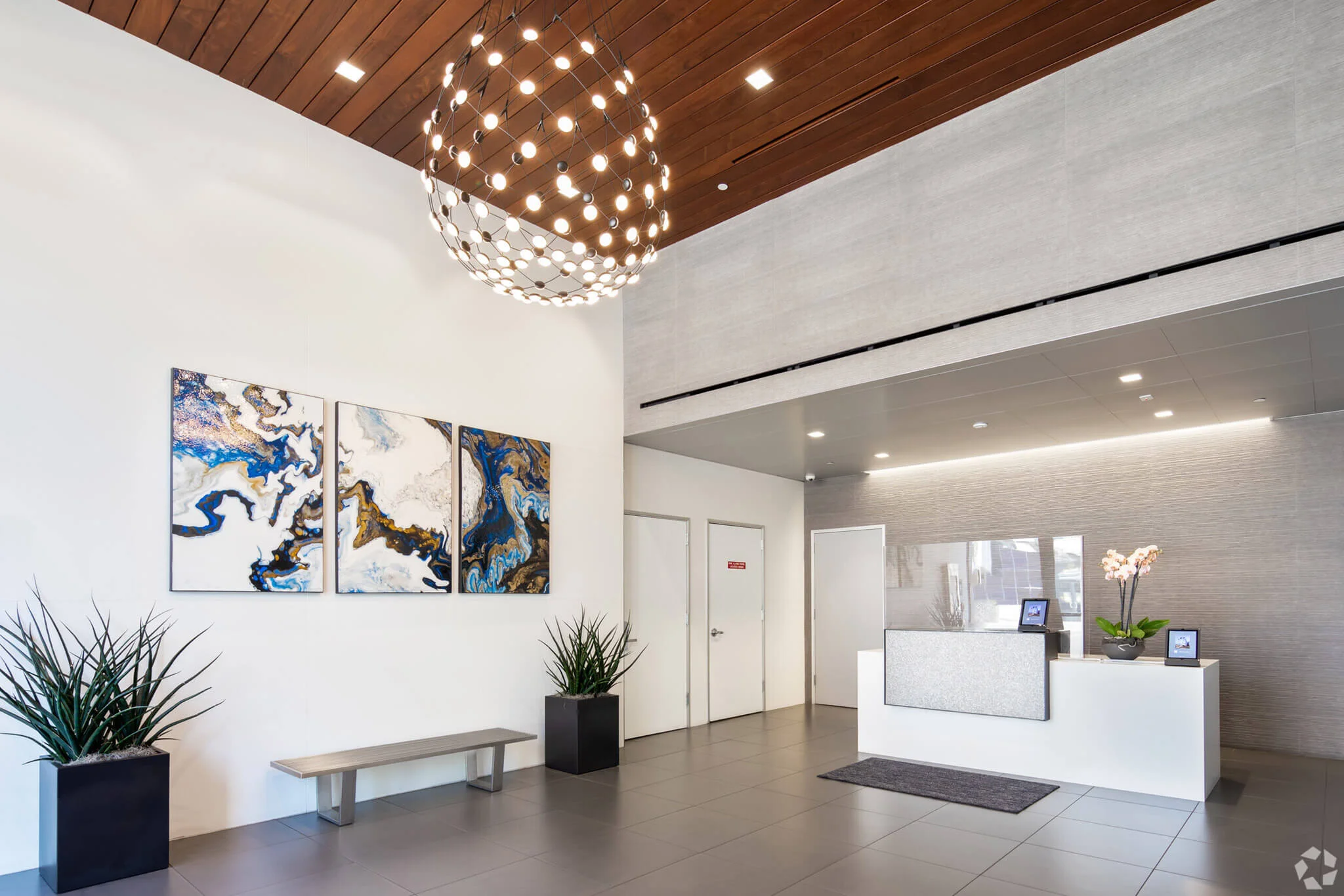 Modern lobby featuring a large painting, showcasing a stylish and inviting atmosphere at YuJa's Office.