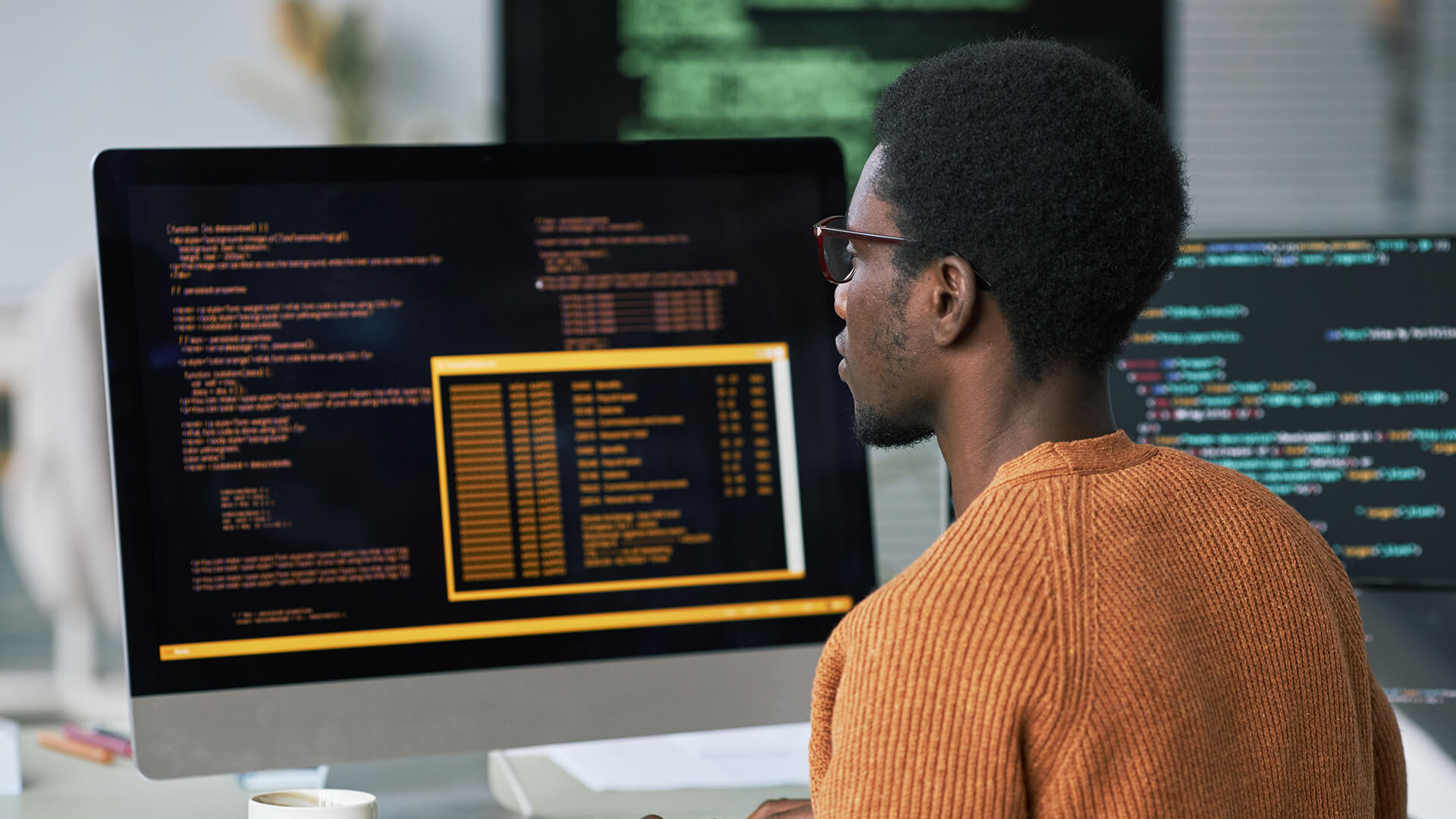 A man goes over complex data on his computer.
